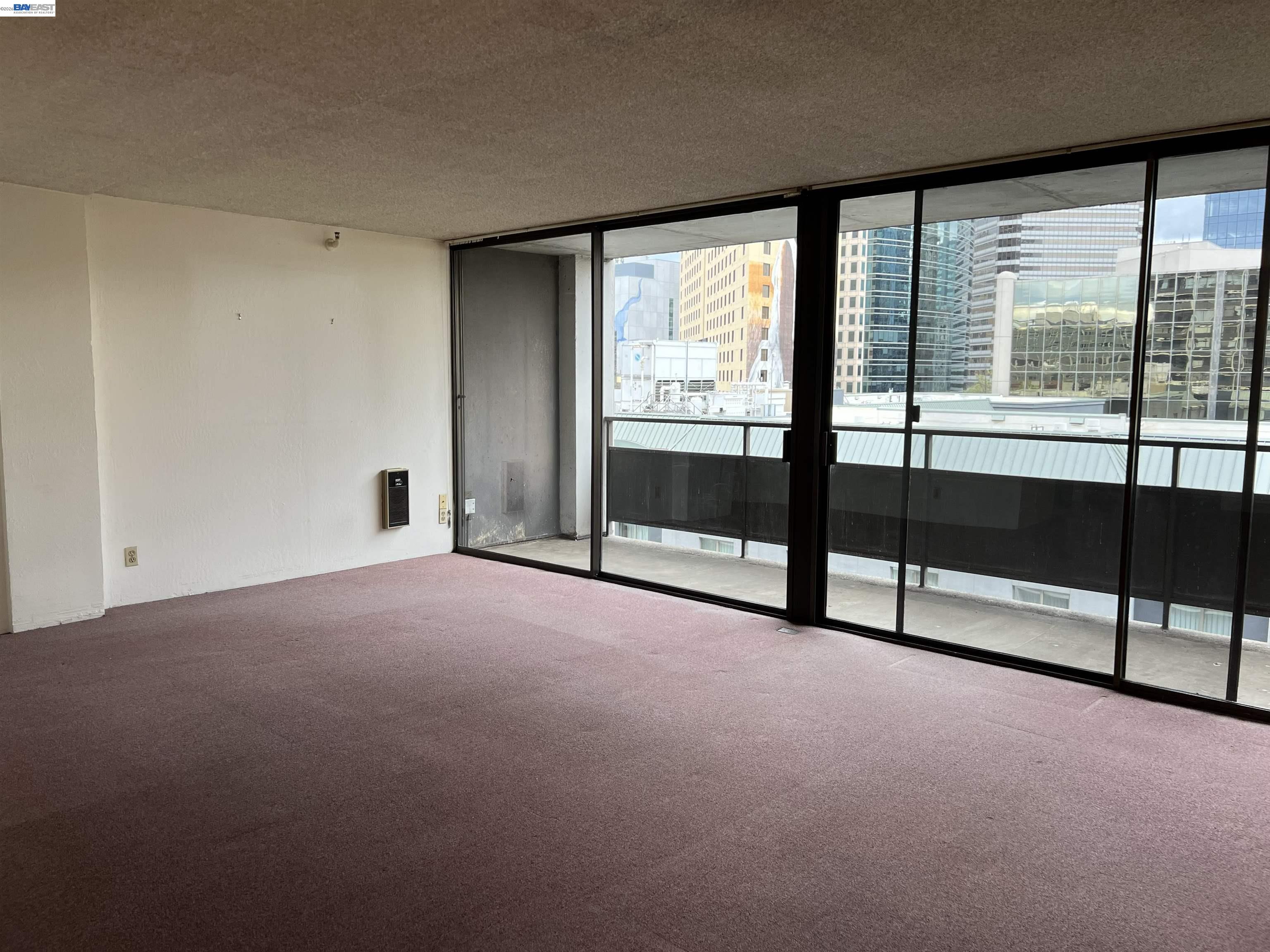 801 Franklin Street, Unit 707 Oakland, CA 94607 - Photo 2 of 14 a view of an empty room with windows and a balcony