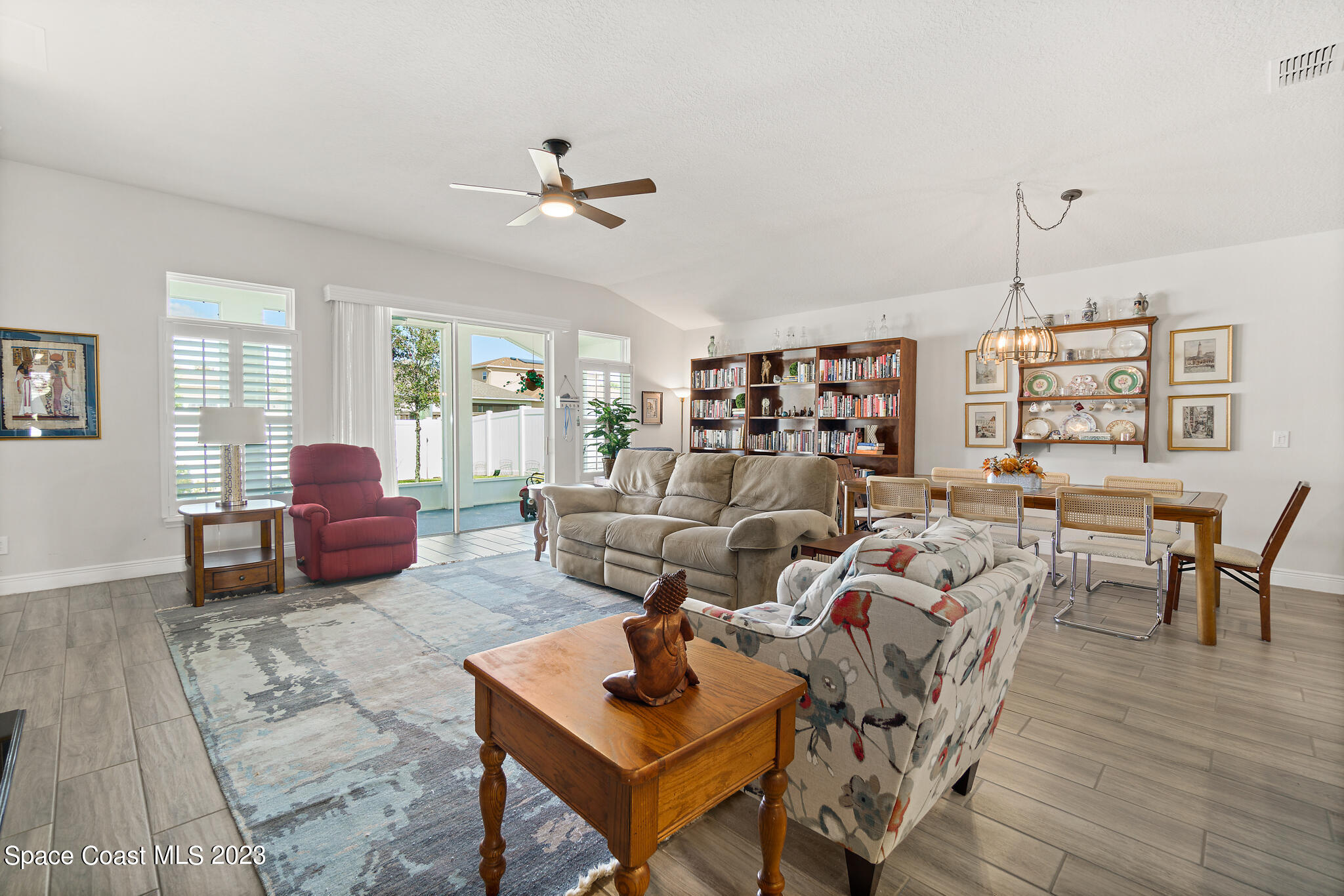 4302 Ruthann Circle Melbourne, FL 32934 - Photo 12 of 45 a living room with furniture ceiling fan and a window