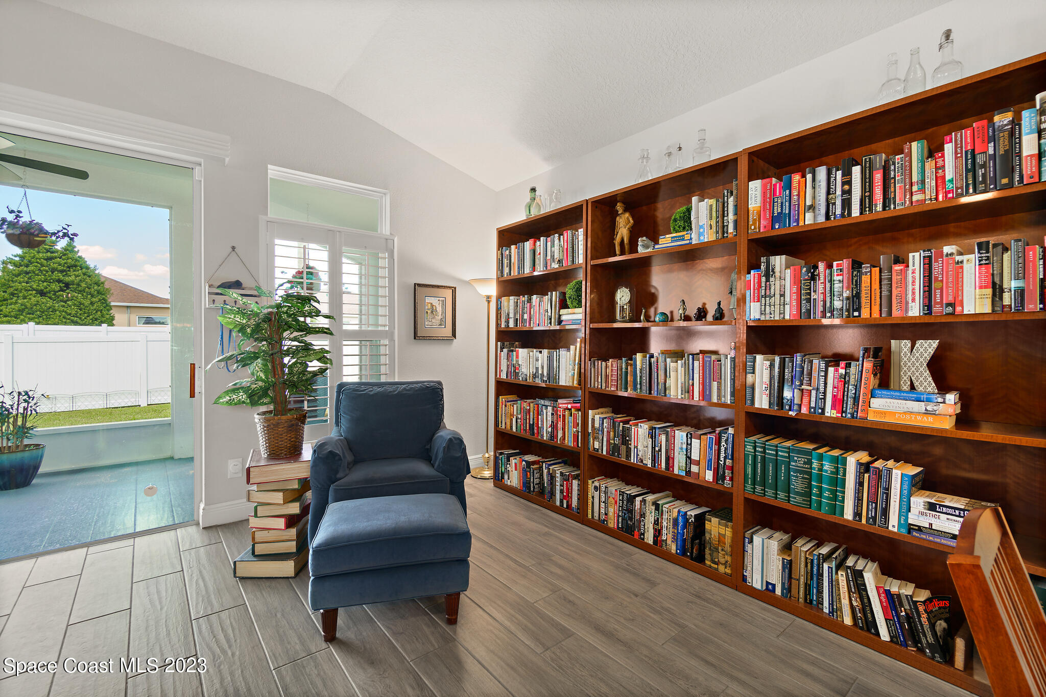 4302 Ruthann Circle Melbourne, FL 32934 - Photo 16 of 45 a living room with furniture and a book shelf