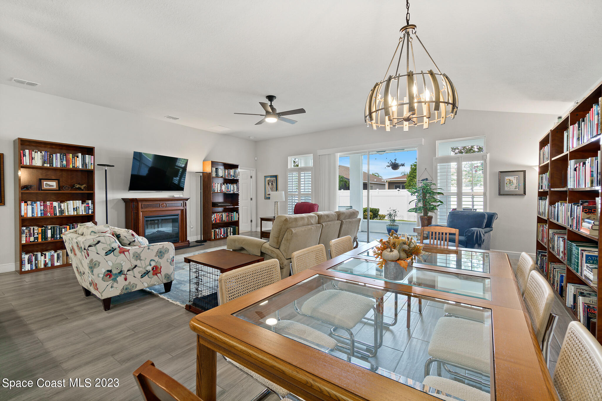 4302 Ruthann Circle Melbourne, FL 32934 - Photo 17 of 45 a living room with fireplace furniture and a chandelier