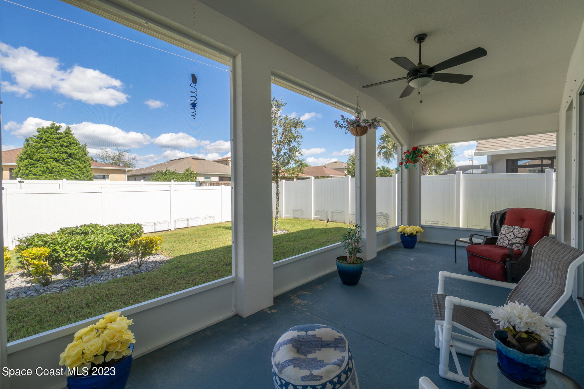 4302 Ruthann Circle Melbourne, FL 32934 - Photo 19 of 45 a living room with patio furniture and a floor to ceiling window