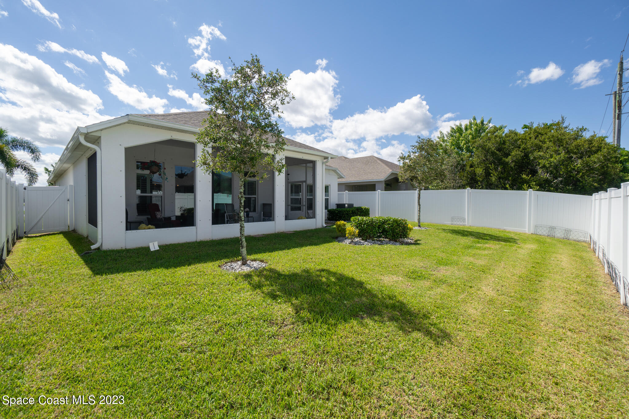 4302 Ruthann Circle Melbourne, FL 32934 - Photo 21 of 45 a view of a house with a swimming pool and a yard