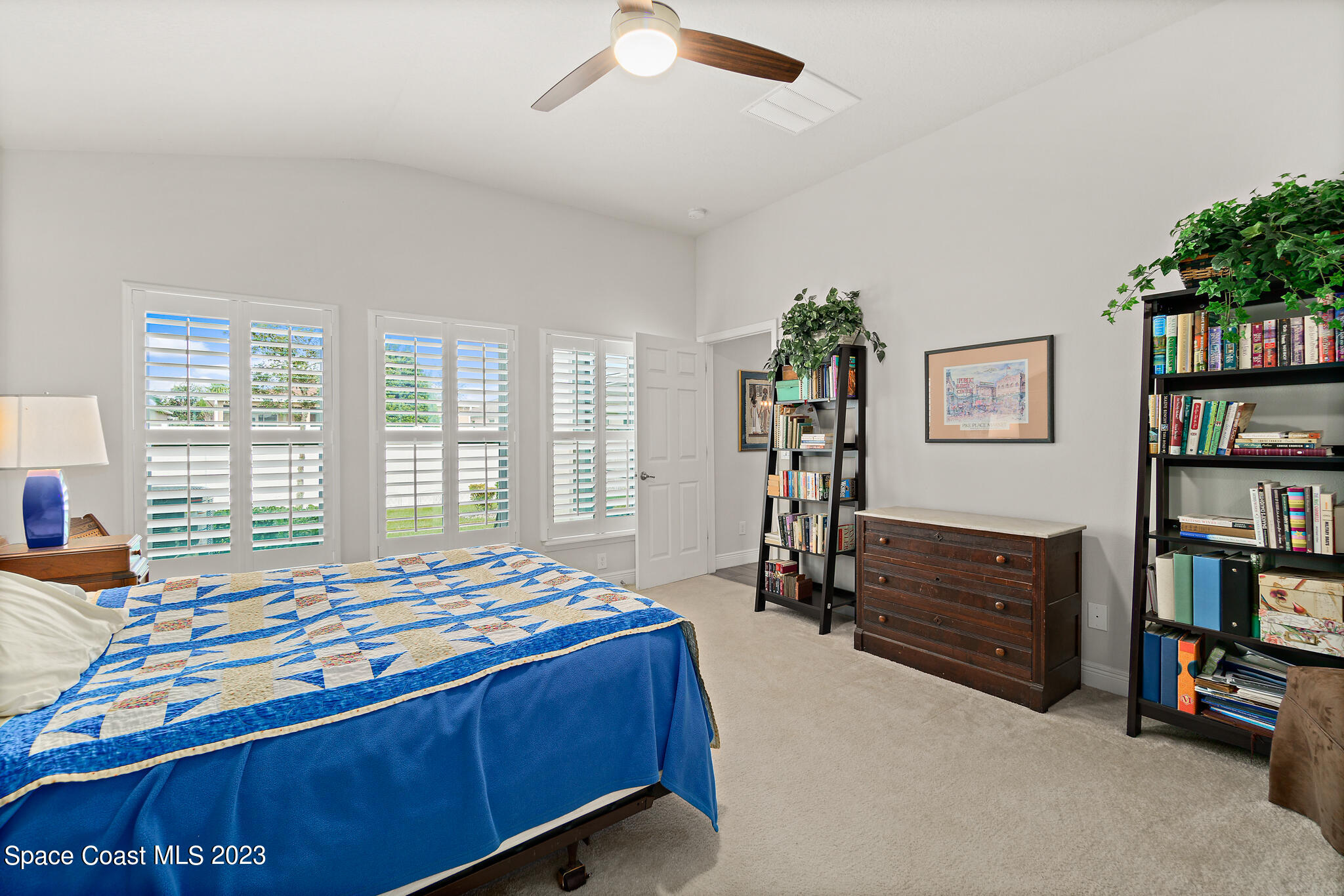 4302 Ruthann Circle Melbourne, FL 32934 - Photo 26 of 45 a bedroom with a bed furniture and a book shelf