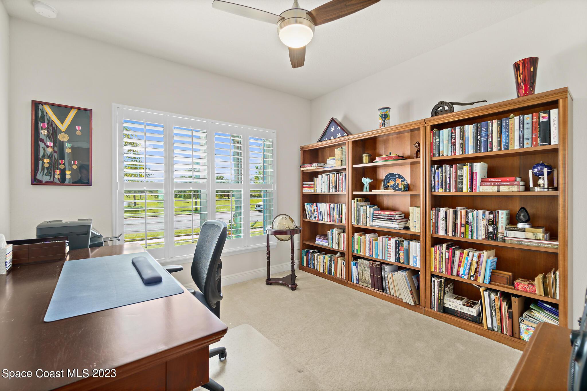 4302 Ruthann Circle Melbourne, FL 32934 - Photo 32 of 45 a view of a livingroom with workspace and a bookshelf
