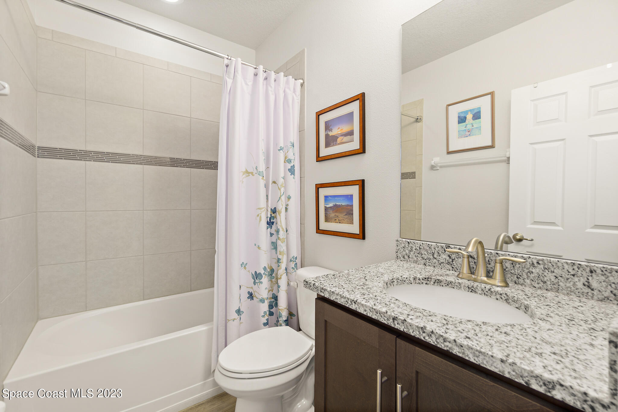 4302 Ruthann Circle Melbourne, FL 32934 - Photo 33 of 45 a bathroom with a granite countertop sink toilet and shower