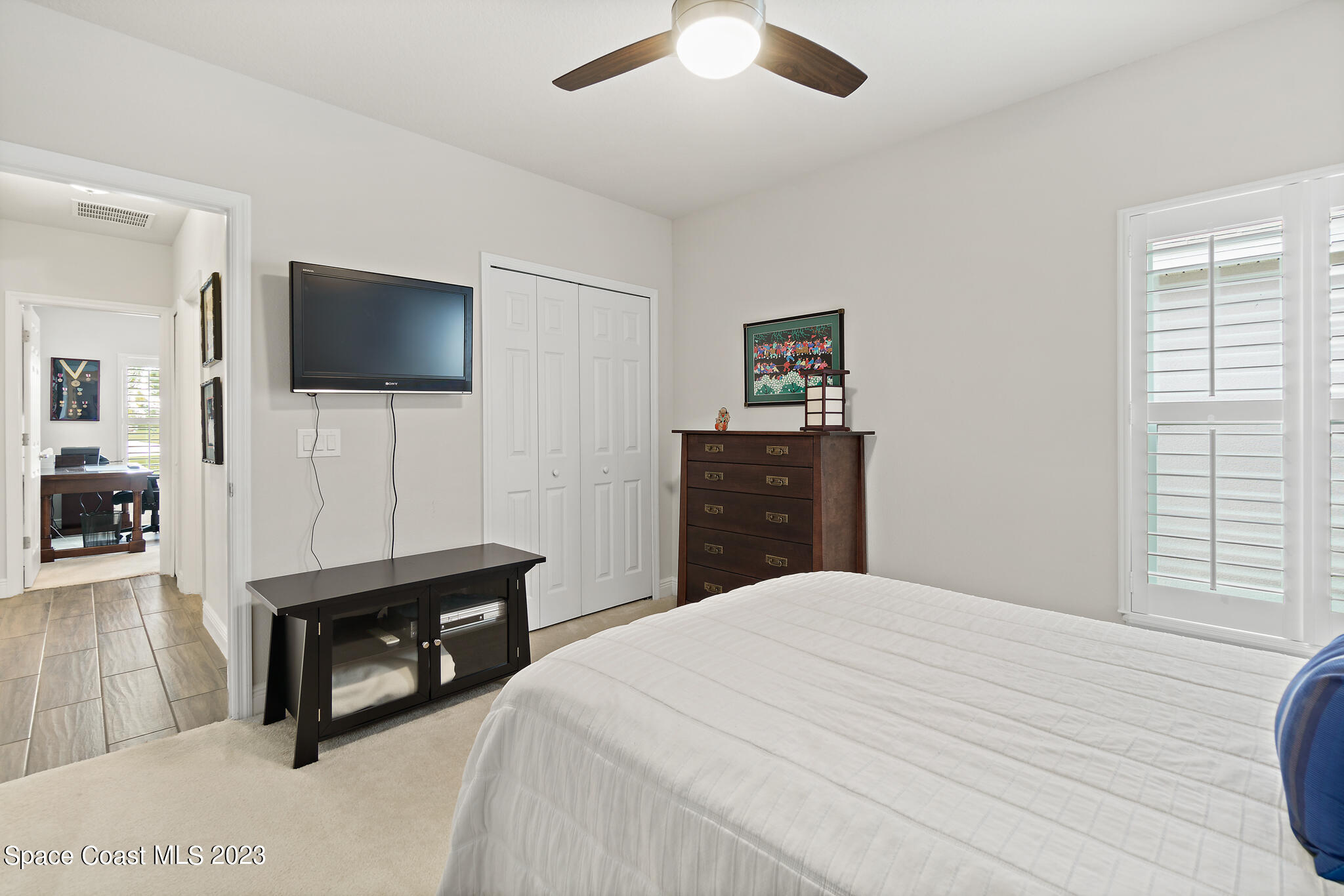4302 Ruthann Circle Melbourne, FL 32934 - Photo 35 of 45 a bedroom with a bed and a flat screen tv