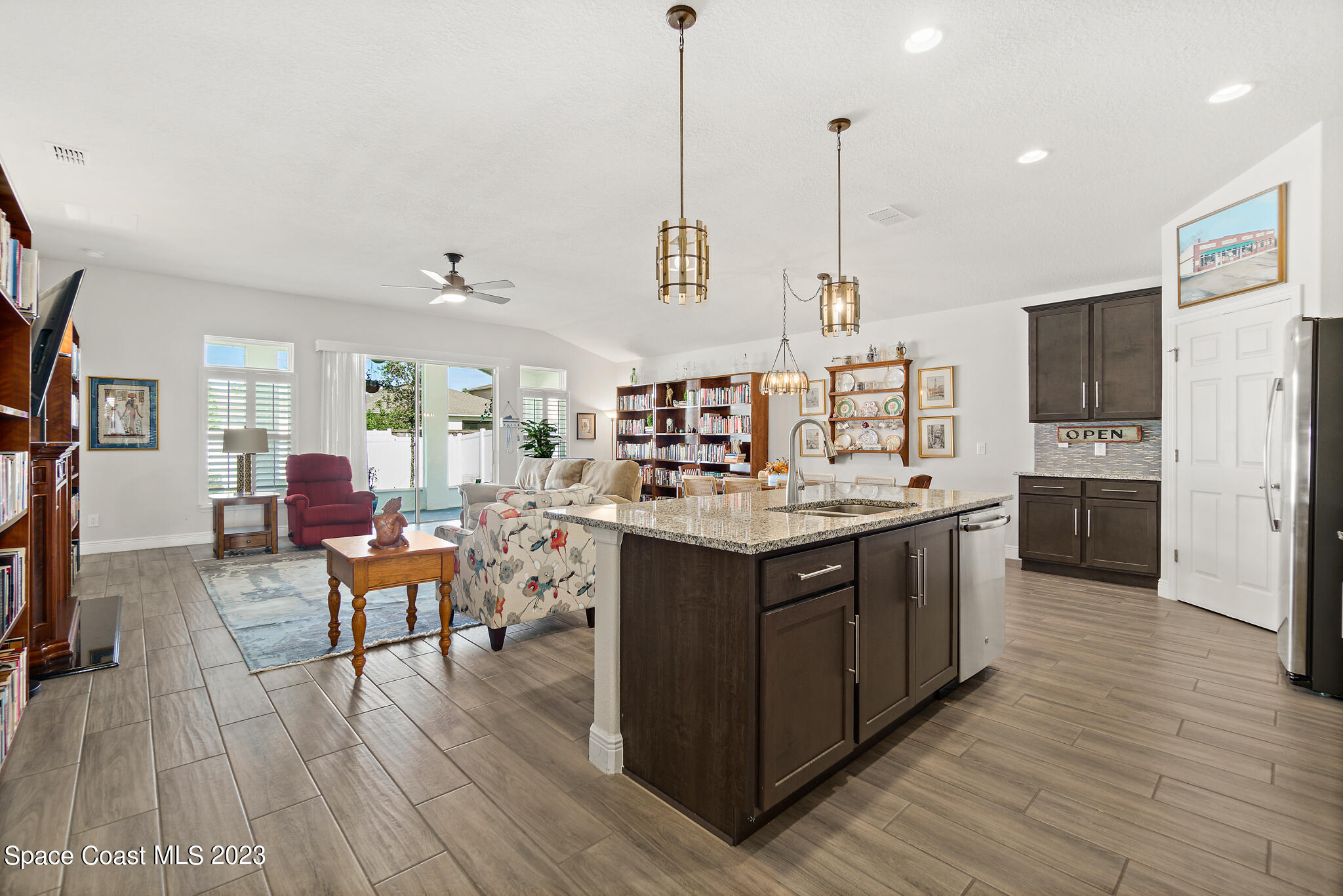 4302 Ruthann Circle Melbourne, FL 32934 - Photo 6 of 45 a kitchen with stainless steel appliances granite countertop wooden floors and sink