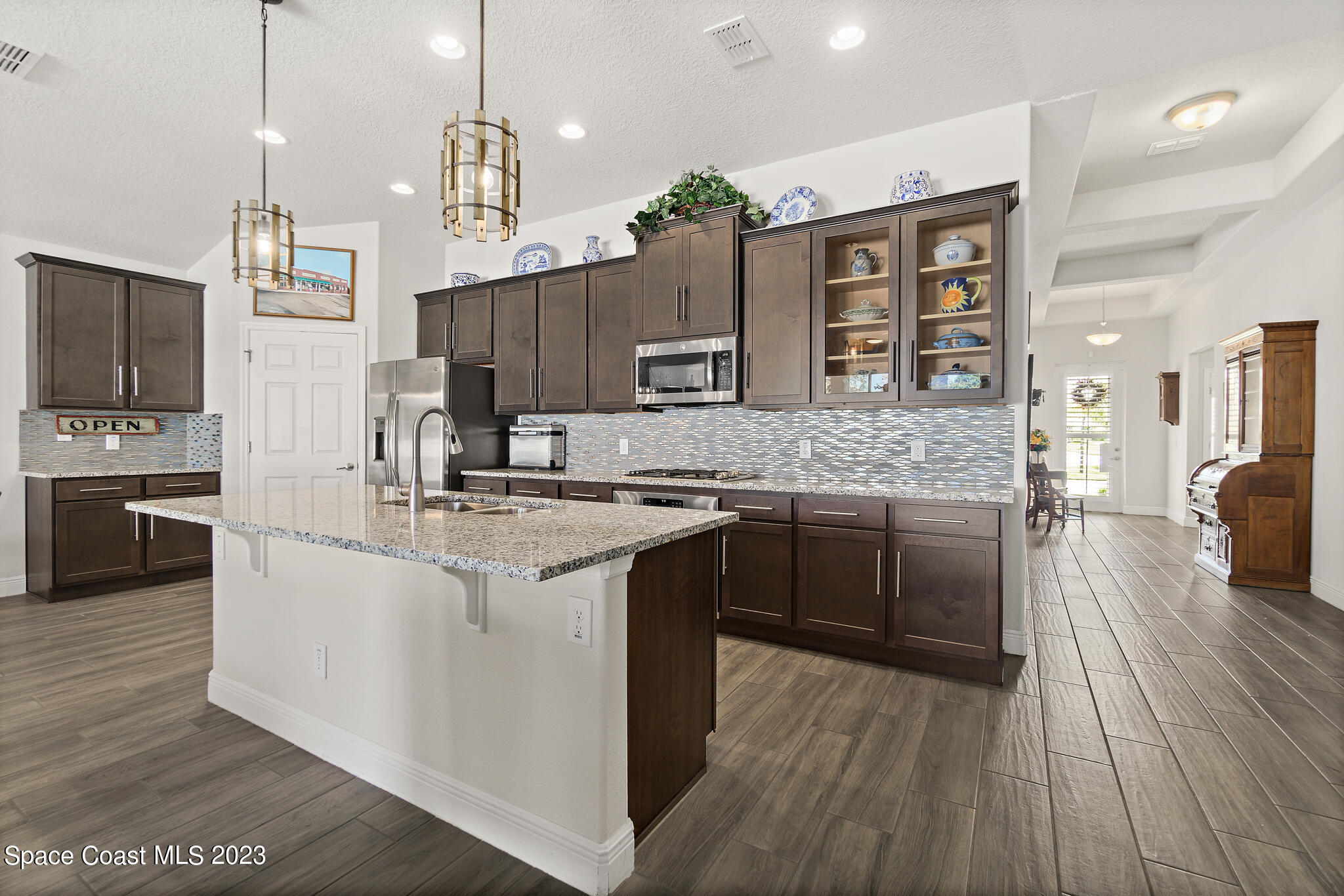 4302 Ruthann Circle Melbourne, FL 32934 - Photo 7 of 45 a large kitchen with stainless steel appliances granite countertop a sink stove and refrigerator