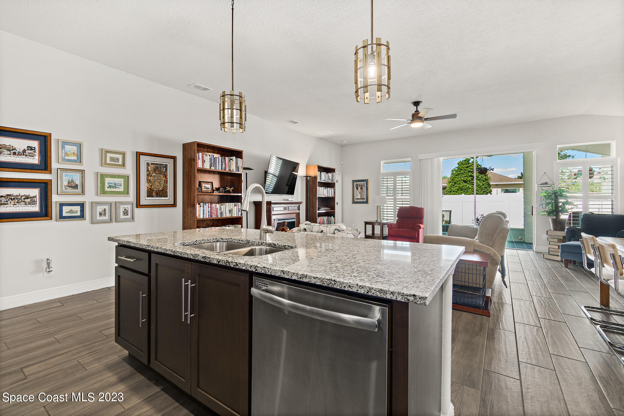 4302 Ruthann Circle Melbourne, FL 32934 - Photo 8 of 45 a view of center island of a kitchen with granite countertop living room and chairs