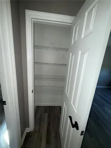 a view of staircase with white walls and a window