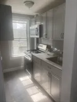 a kitchen with kitchen island and a window