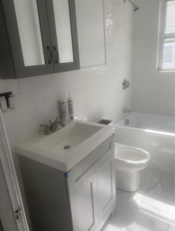 583 Center Street, Unit 2 Fall River, MA 02724 - Photo 3 of 6 a bathroom with a sink toilet and bathtub