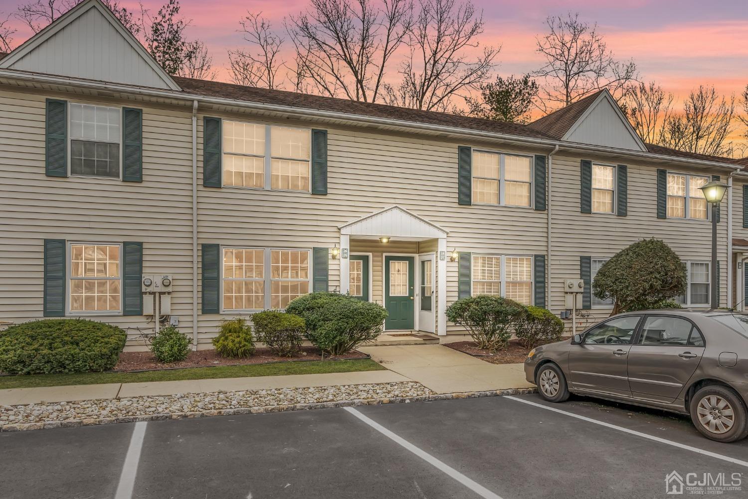 a car parked in front of a white house