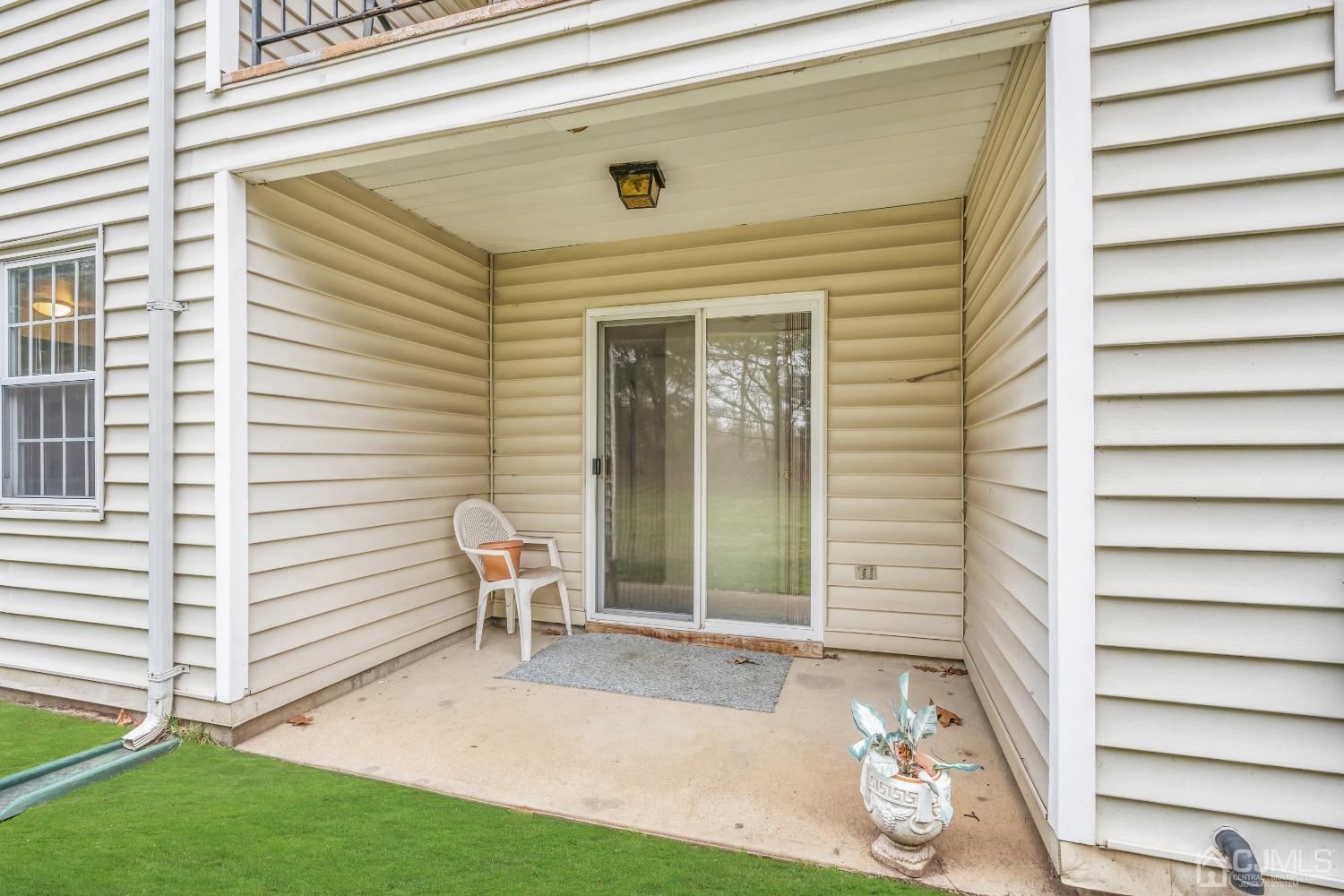25 Hanover Square Middlesex, NJ 08846 - Photo 13 of 15 a view of a porch with a table and chairs and potted plants