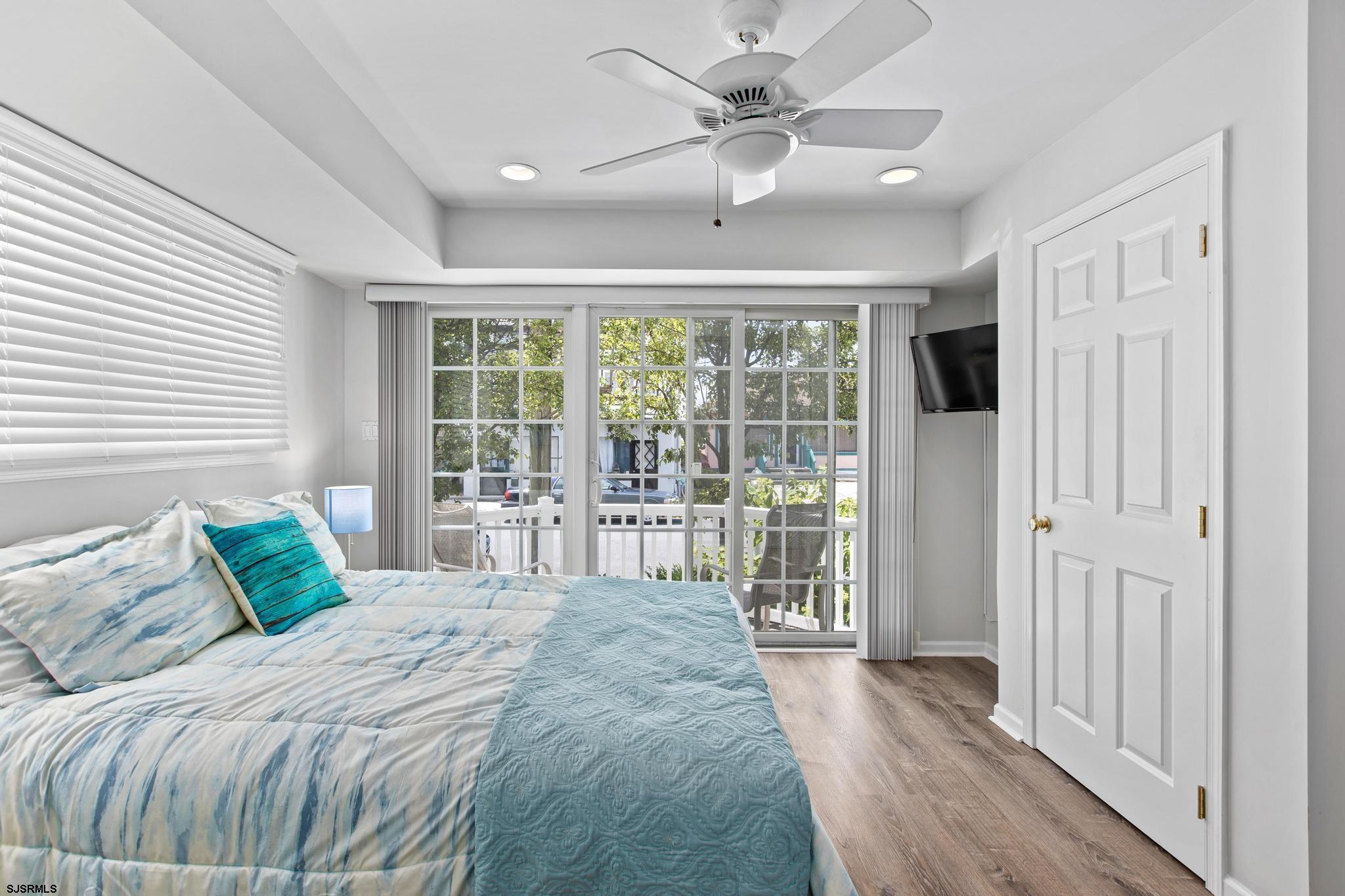1 South Douglas Avenue, Unit 1 Margate City, NJ 08402 - Photo 12 of 48 a bedroom with a large bed and a large window