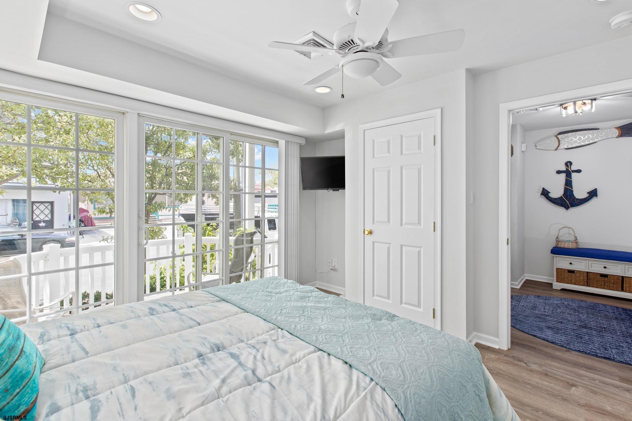 1 South Douglas Avenue, Unit 1 Margate City, NJ 08402 - Photo 13 of 48 a bedroom with a bed and a large window