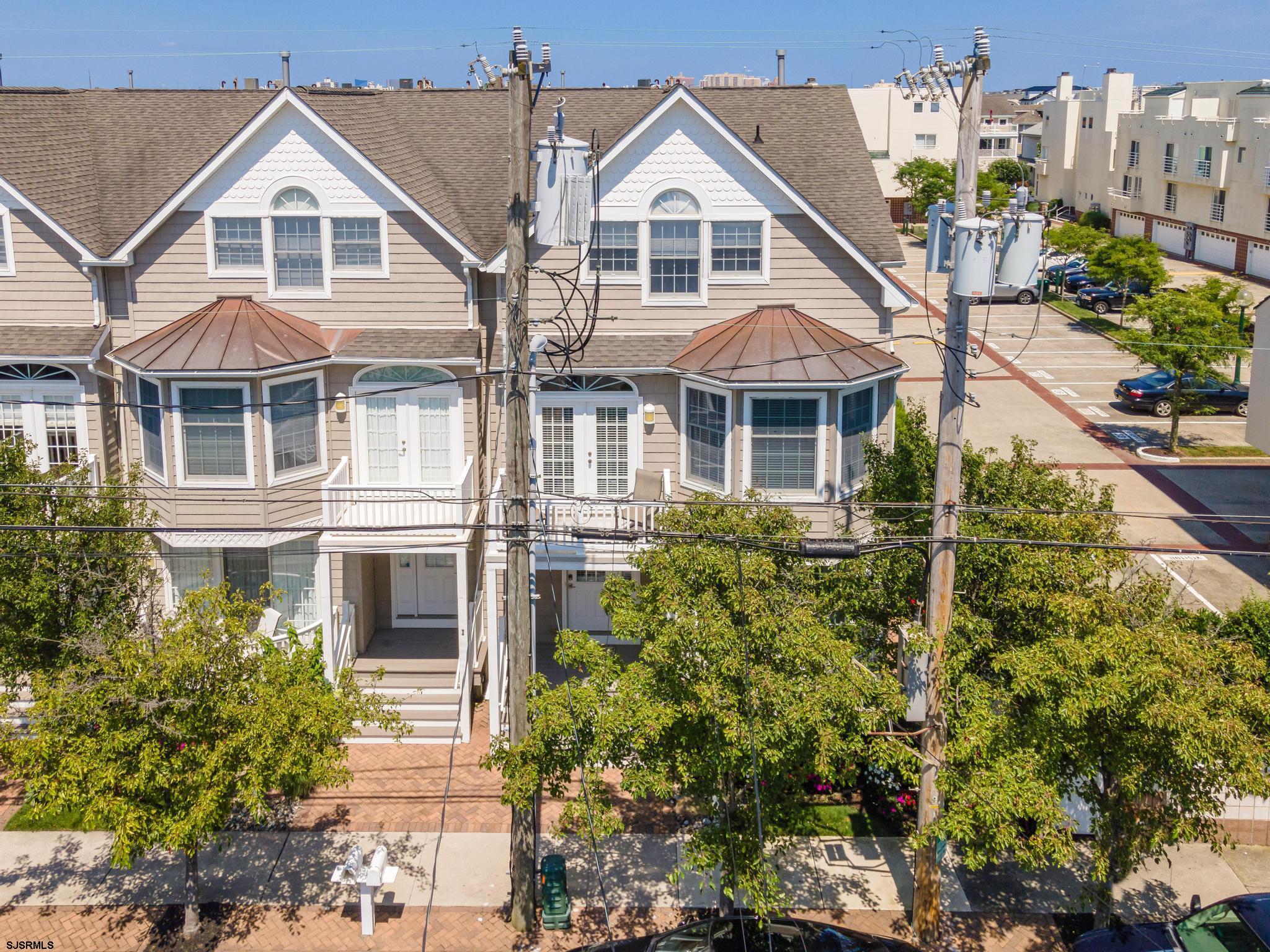 1 South Douglas Avenue, Unit 1 Margate City, NJ 08402 - Photo 2 of 48 a view of white house with a yard and potted plants