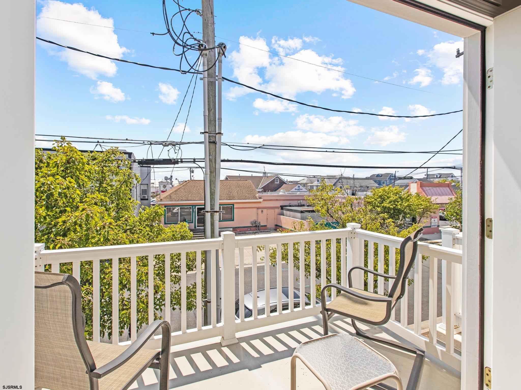 1 South Douglas Avenue, Unit 1 Margate City, NJ 08402 - Photo 23 of 48 a view of a balcony with chairs