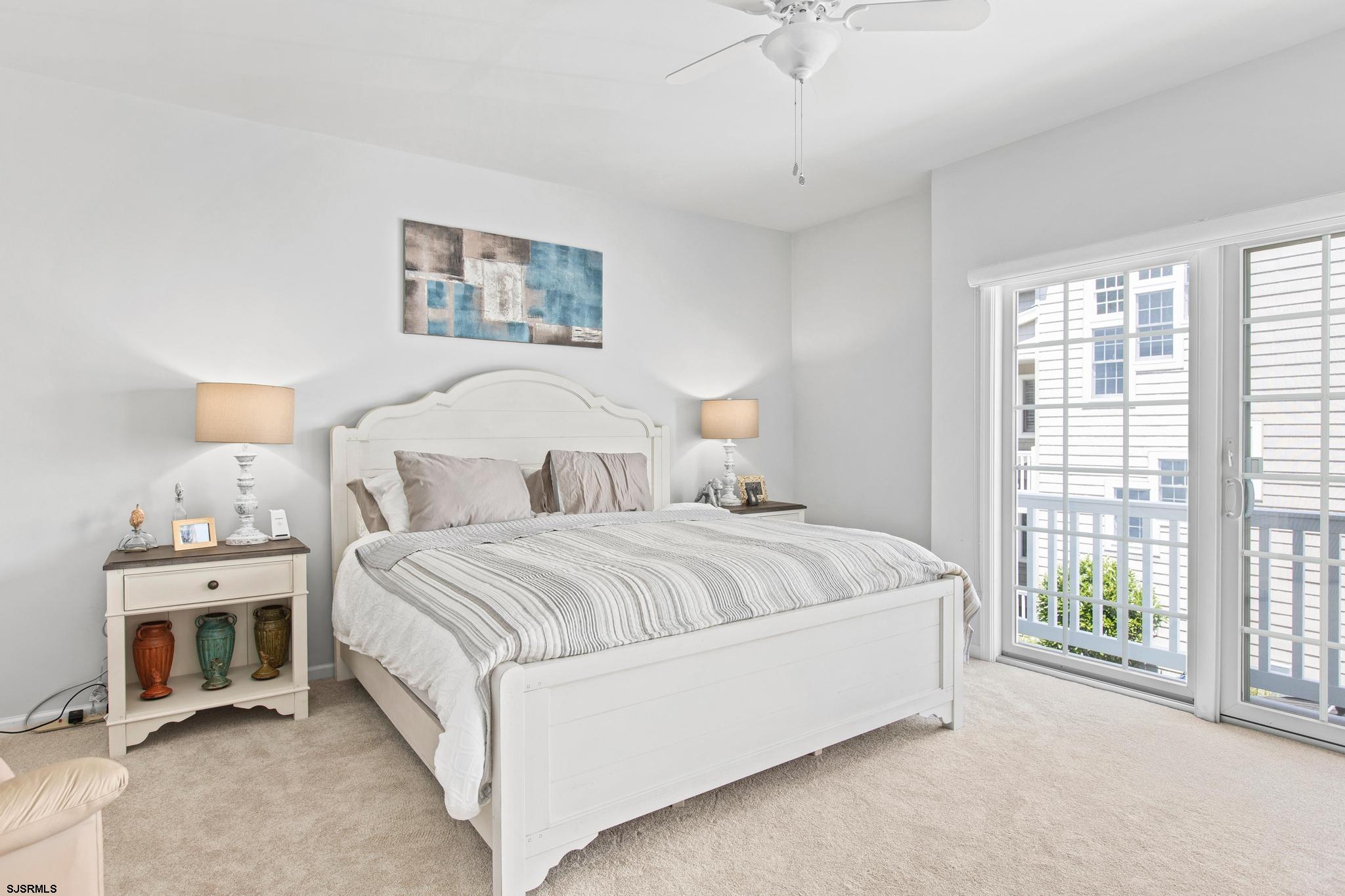 1 South Douglas Avenue, Unit 1 Margate City, NJ 08402 - Photo 26 of 48 a spacious bedroom with a bed and a large window