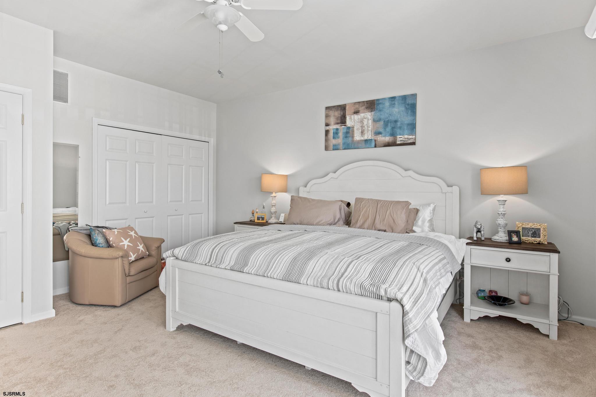 1 South Douglas Avenue, Unit 1 Margate City, NJ 08402 - Photo 27 of 48 a bedroom with a bed and a couch