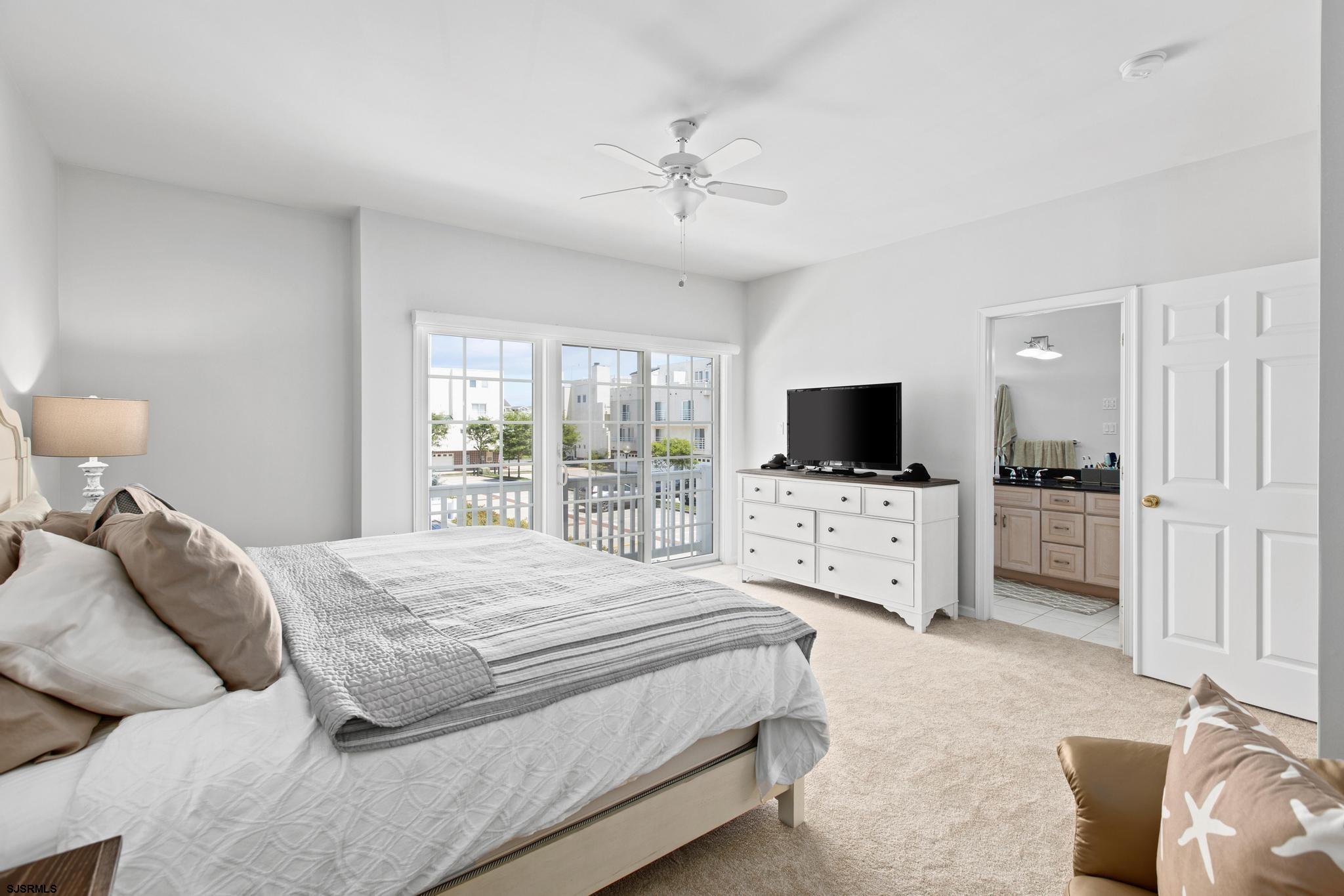 1 South Douglas Avenue, Unit 1 Margate City, NJ 08402 - Photo 28 of 48 a bedroom with a bed and a flat screen tv