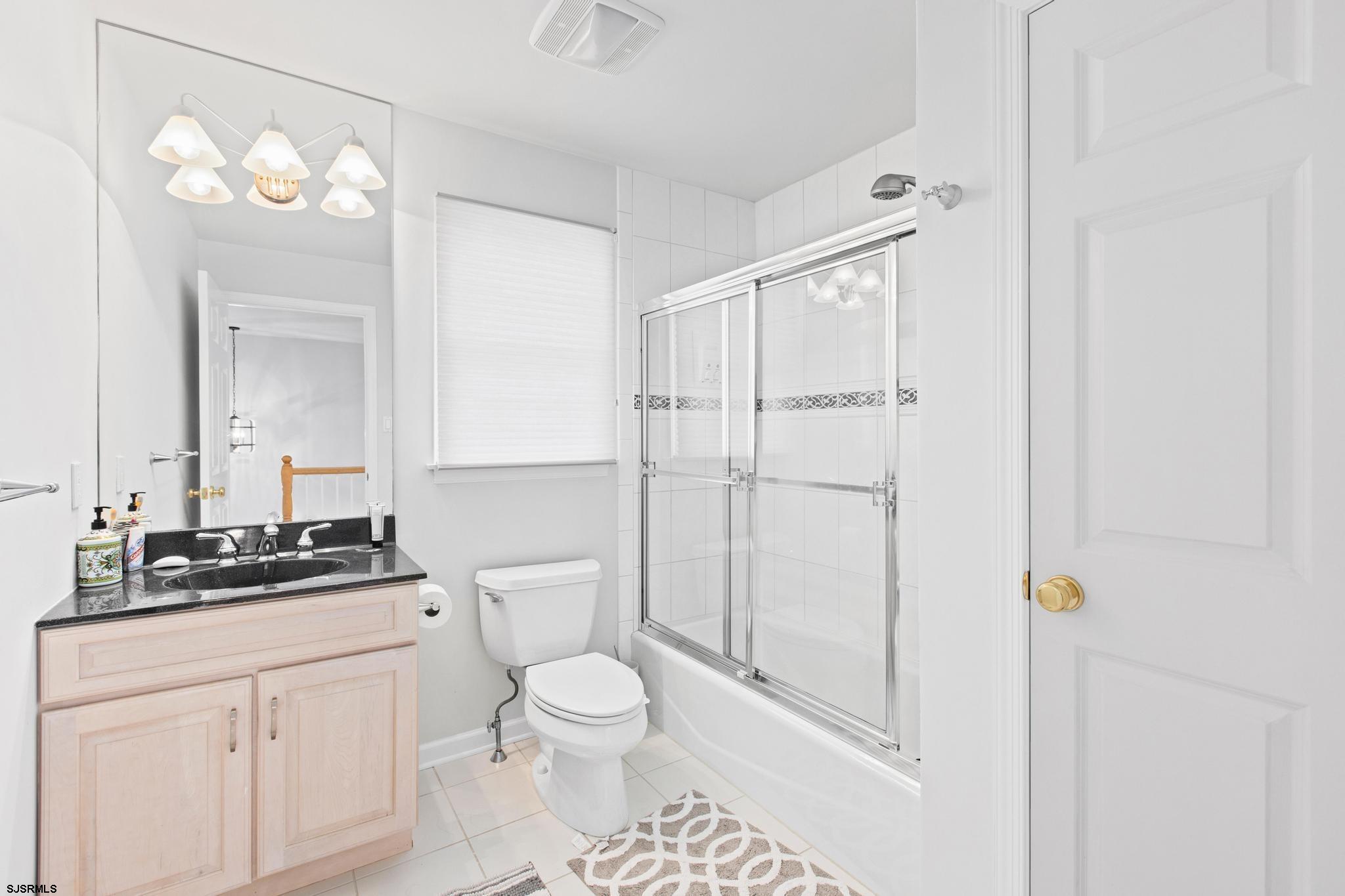 1 South Douglas Avenue, Unit 1 Margate City, NJ 08402 - Photo 34 of 48 a bathroom with a toilet a sink and a mirror