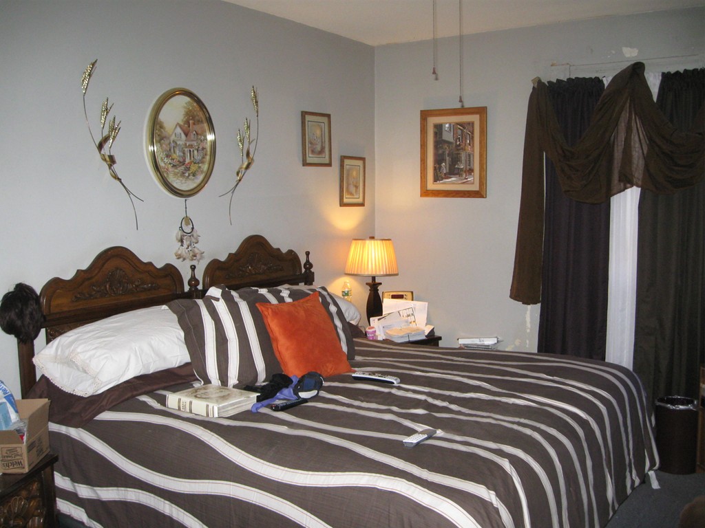288-290 Oak Street Springfield, MA 01151 - Photo 14 of 18 a bedroom with a bed and dresser with wooden floor