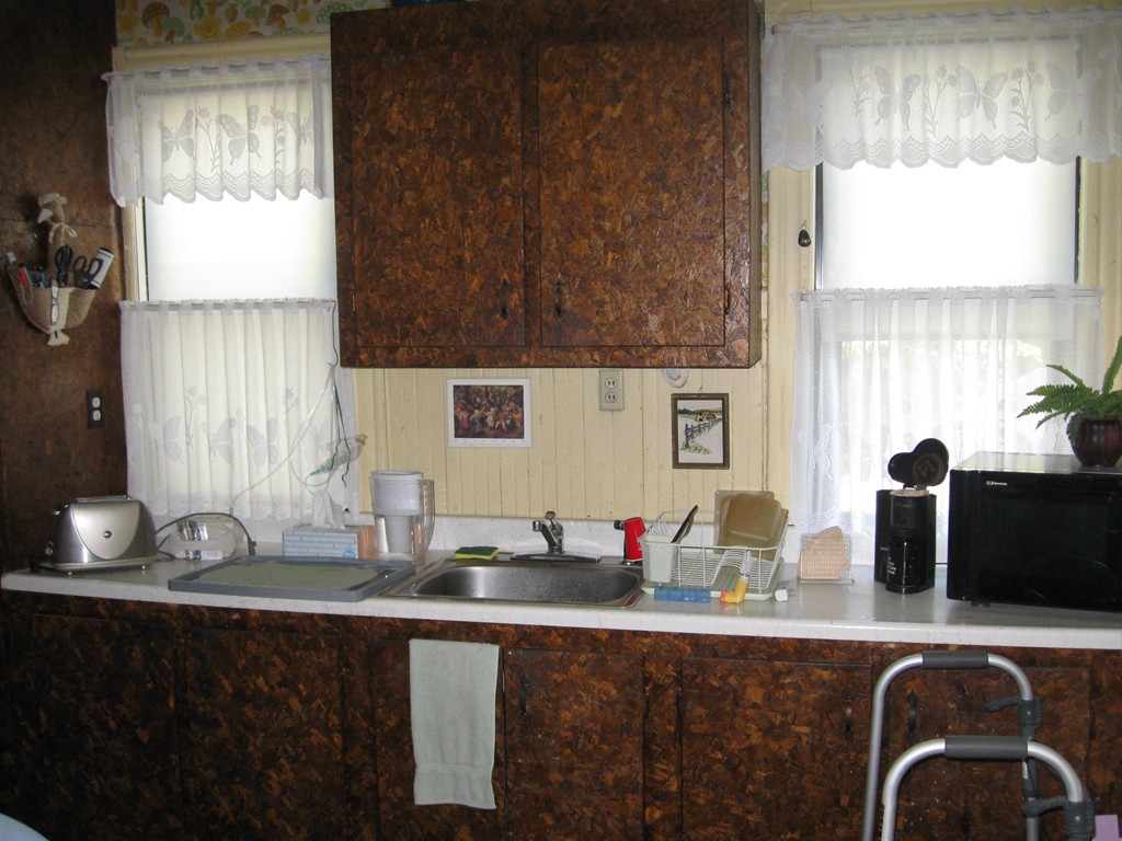 288-290 Oak Street Springfield, MA 01151 - Photo 9 of 18 a kitchen with granite countertop a sink and a wooden cabinets