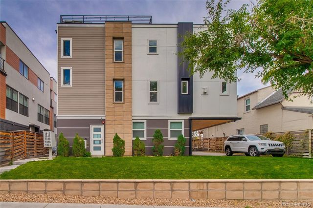 a front view of a building with a garden