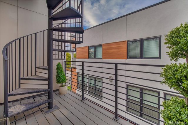 a view of a balcony with a potted plant and stairs