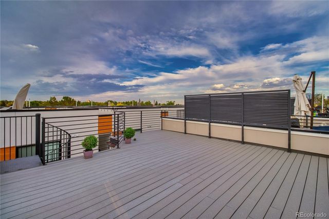 a view of a terrace with wooden floor and city view