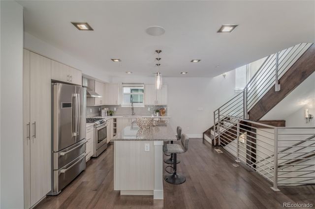 a kitchen with cabinets and refrigerator