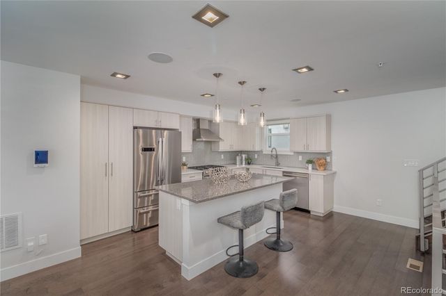 a kitchen with appliances cabinets and a counter top space