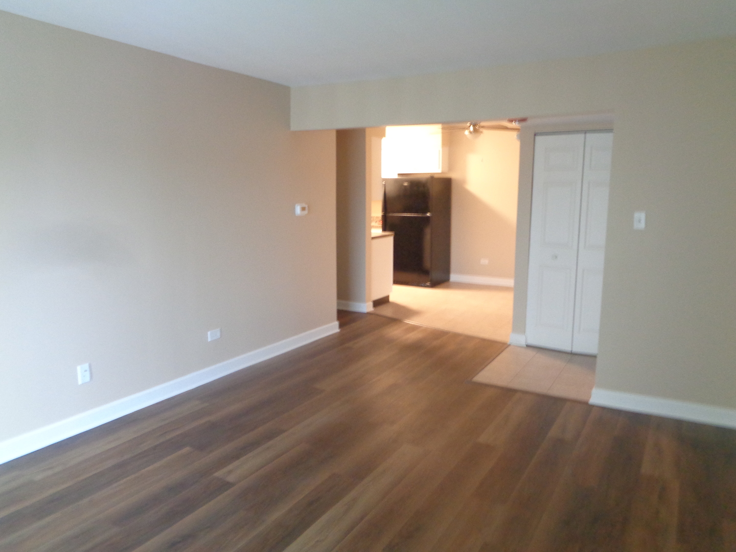 10442 Brooks Lane, Unit C1 Chicago Ridge, IL 60415 - Photo 3 of 12 a view of a hallway with wooden floor and a refrigerator