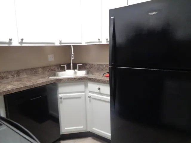 a kitchen with a sink and a refrigerator
