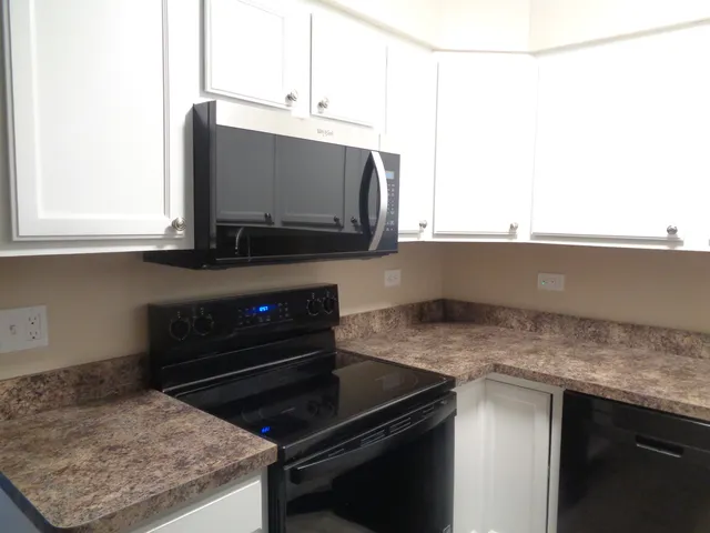 a kitchen with a stove and a microwave