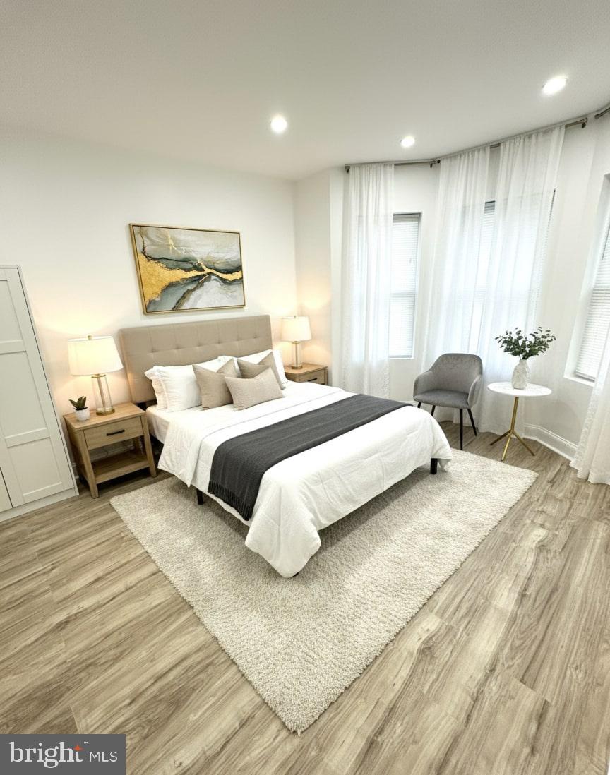 5542 Pemberton Street Philadelphia, PA 19143 - Photo 12 of 22 a bedroom with a bed and wooden floor