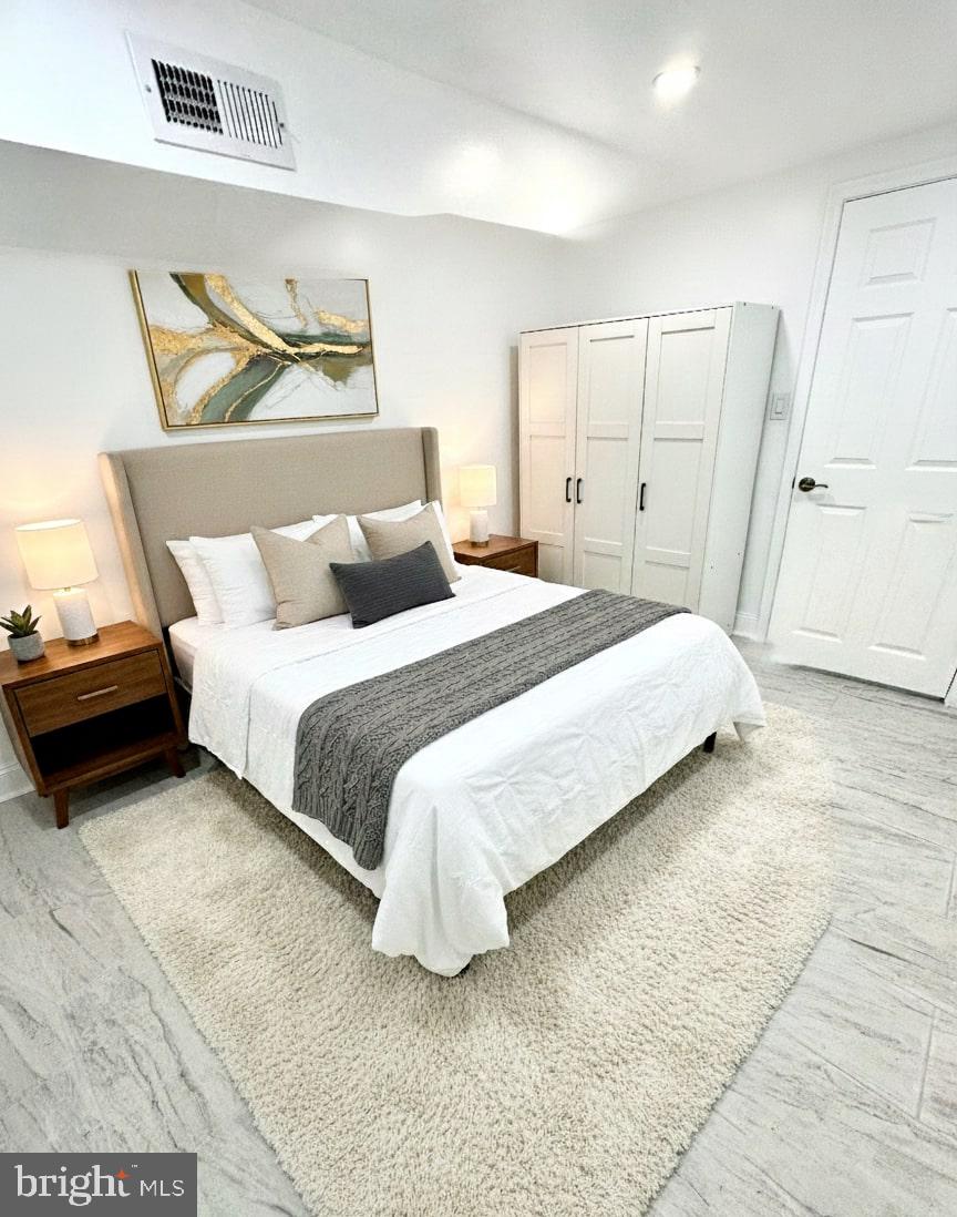 5542 Pemberton Street Philadelphia, PA 19143 - Photo 14 of 22 a bedroom with a bed and a painting on the wall