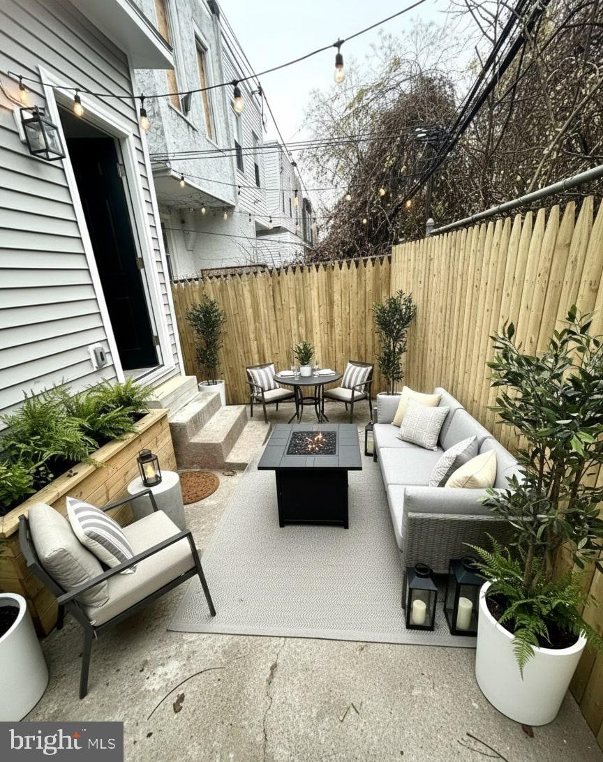 5542 Pemberton Street Philadelphia, PA 19143 - Photo 17 of 22 a living room with patio furniture and a potted plant