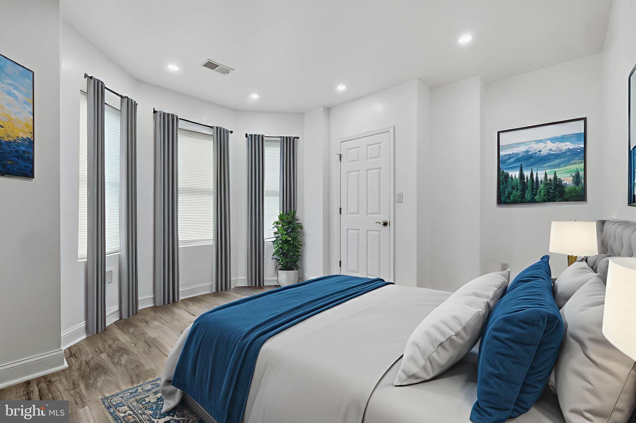 5542 Pemberton Street Philadelphia, PA 19143 - Photo 6 of 22 a bedroom with a large bed and a painting on the wall