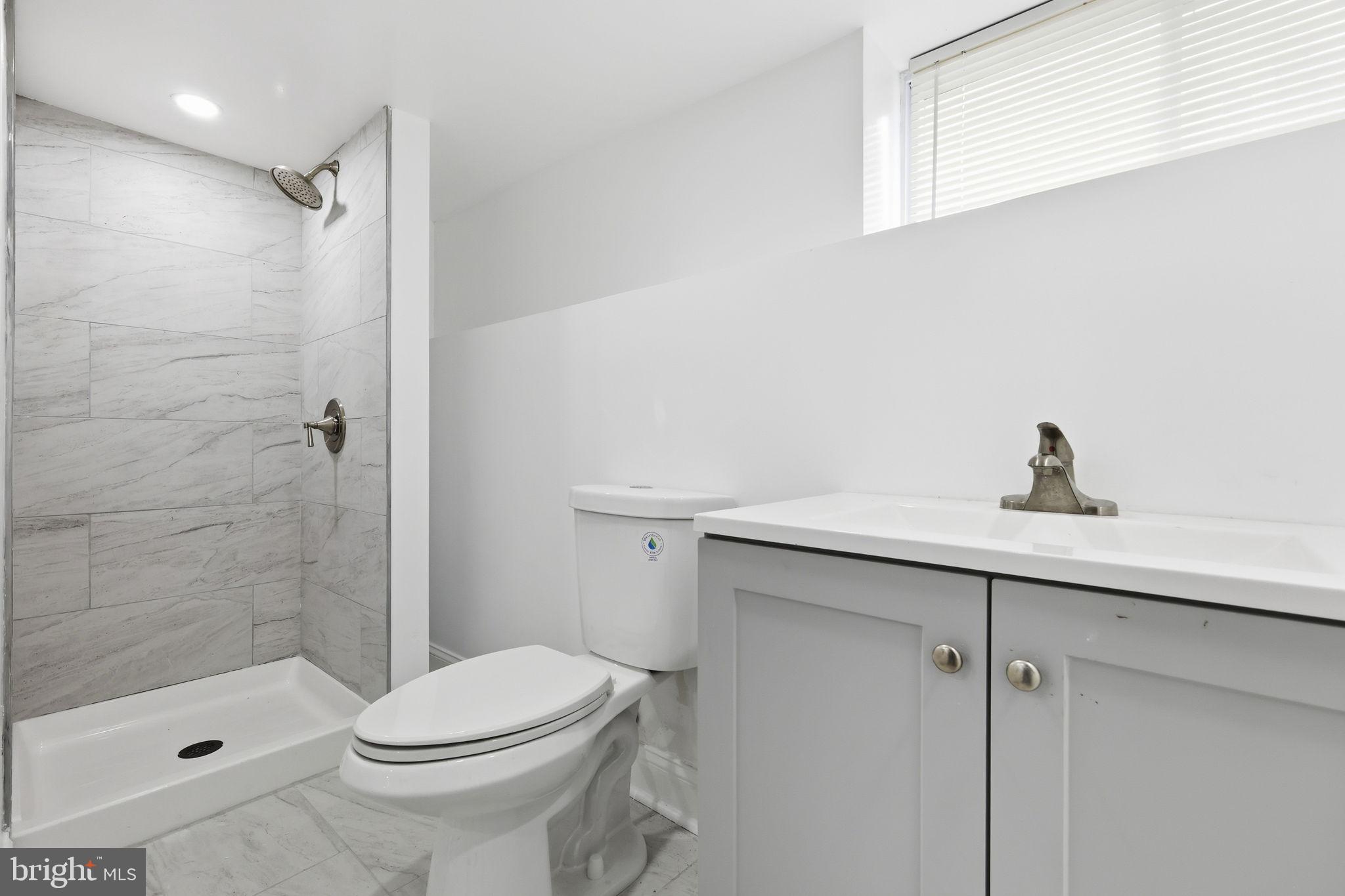 5542 Pemberton Street Philadelphia, PA 19143 - Photo 7 of 22 a bathroom with a sink a toilet and shower