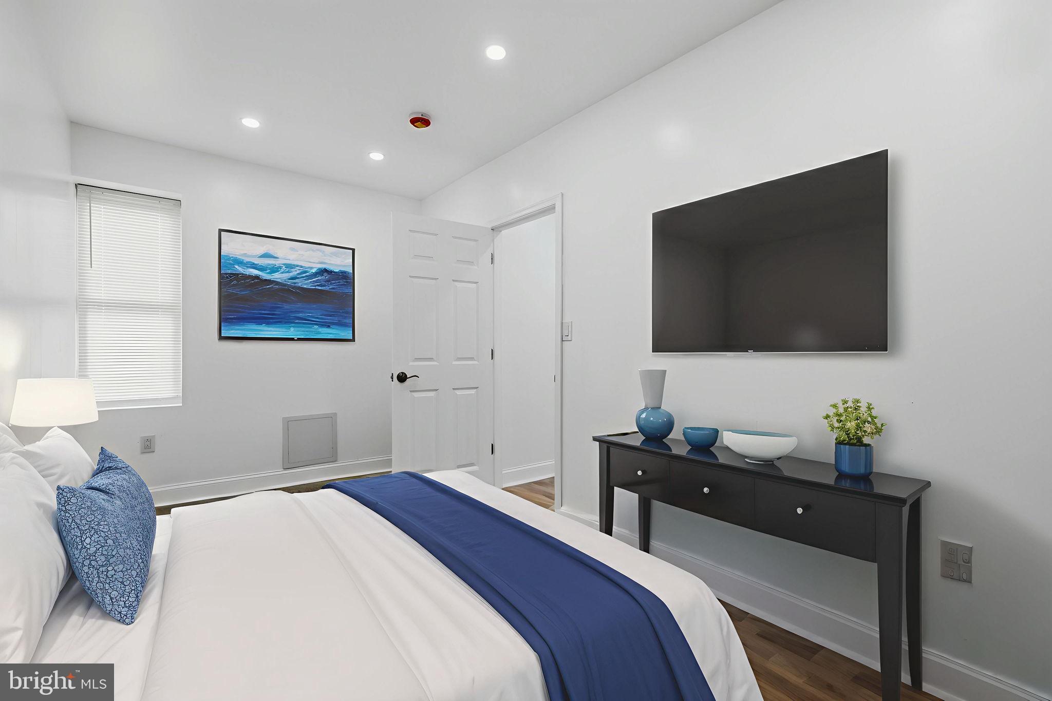 5542 Pemberton Street Philadelphia, PA 19143 - Photo 8 of 22 a bedroom with a bed and a flat screen tv