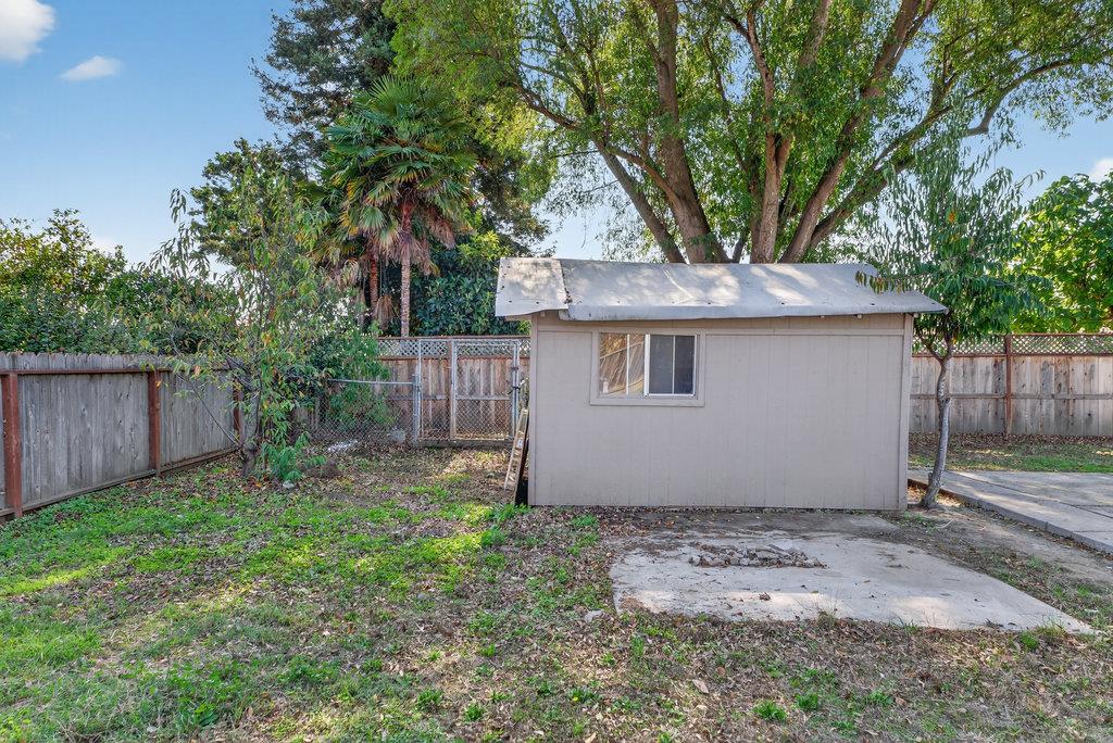 136 Lester Court Watsonville, CA 95076 - Photo 32 of 32 a backyard of a house with a fountain plants and large tree
