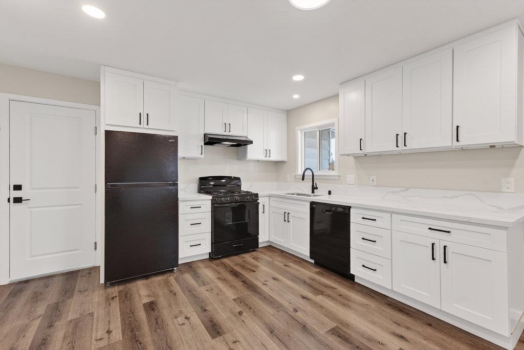 136 Lester Court Watsonville, CA 95076 - Photo 4 of 32 a kitchen with a refrigerator stove and white cabinets