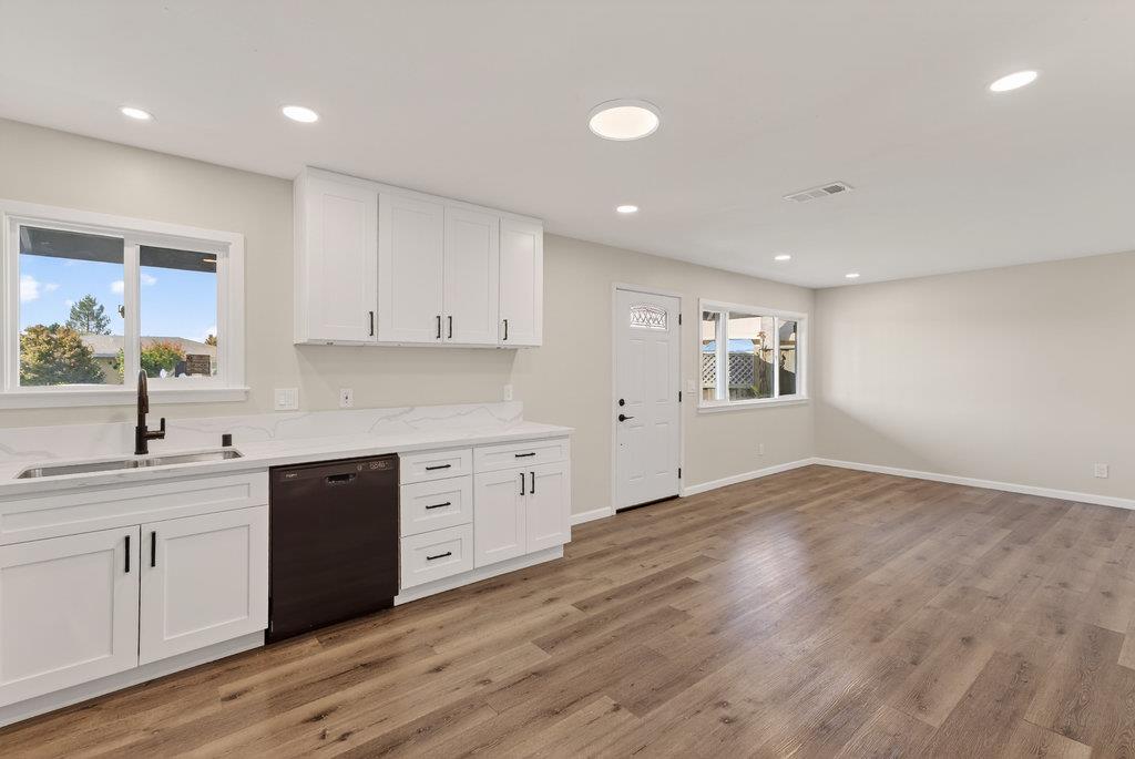 136 Lester Court Watsonville, CA 95076 - Photo 7 of 32 a kitchen with granite countertop a sink and cabinets