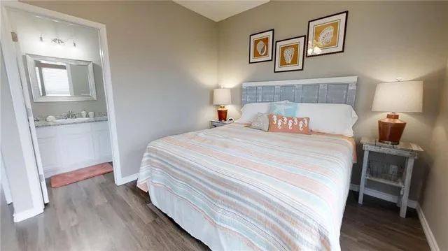 a bedroom with a bed a flat screen tv and dresser