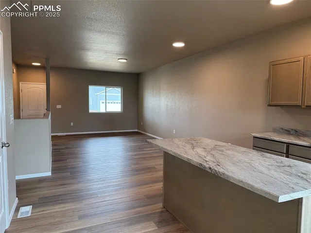 a hallway with wooden floor and window