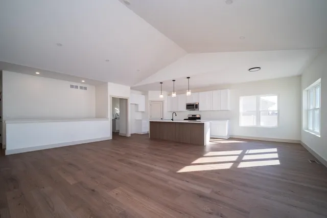 a view of kitchen and kitchen with wooden floor