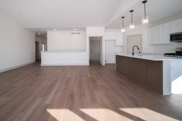 a view of kitchen with wooden floor and window