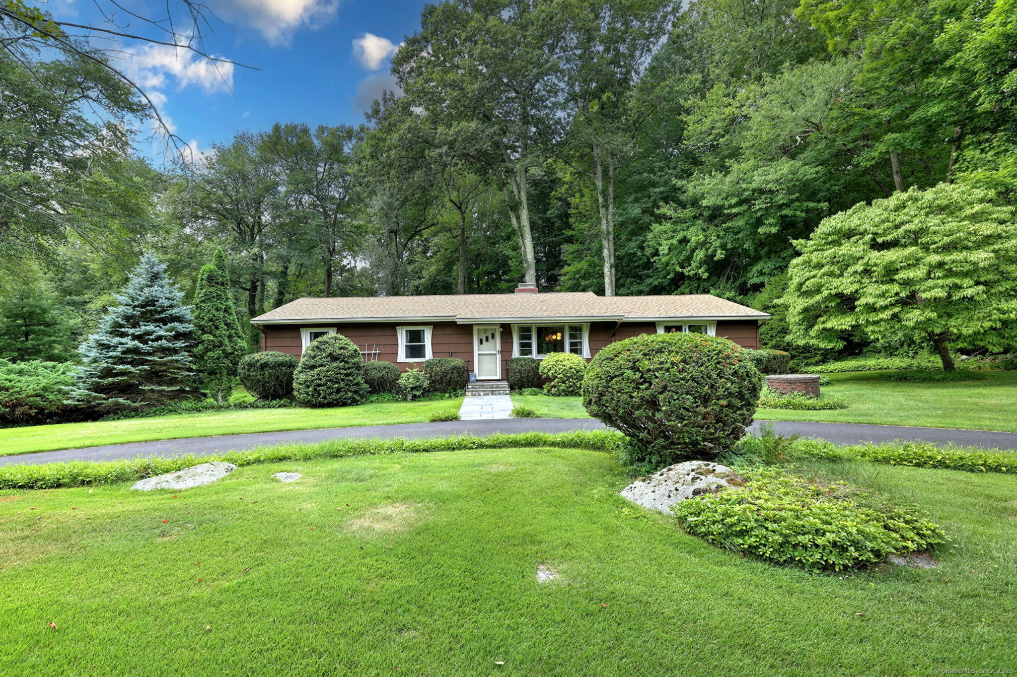 a front view of a house with a garden
